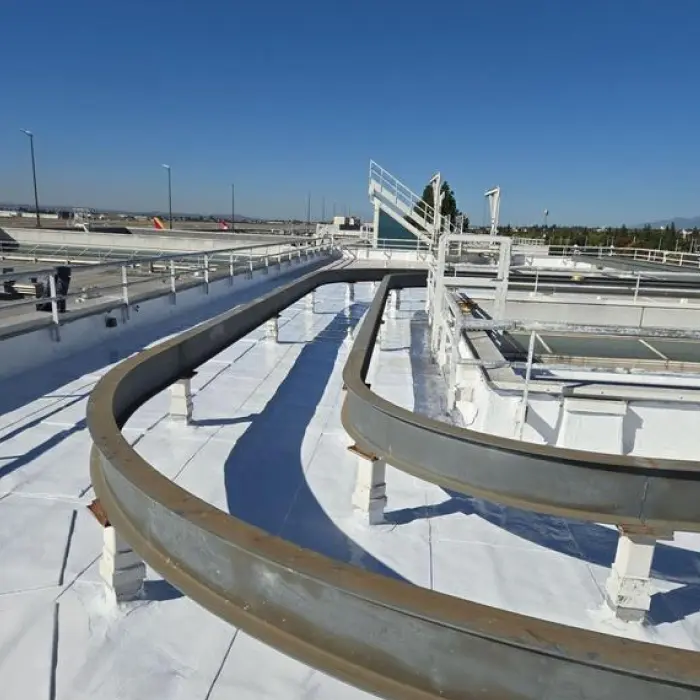 Industrial water treatment facility walkway with roof coating
