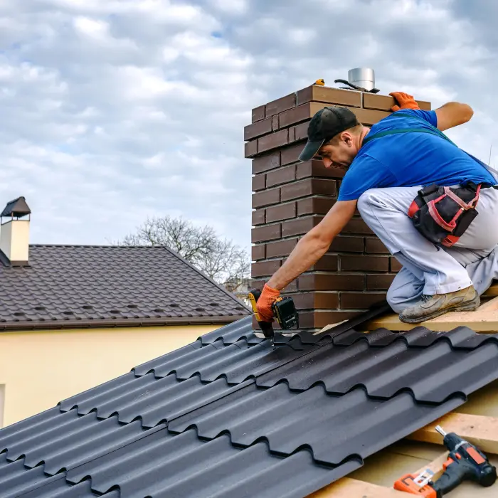 a professional roofer with electric screwdriver covers repairs the roof