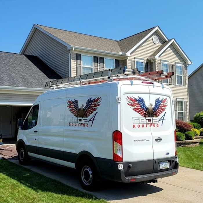 Roofing van parked near house